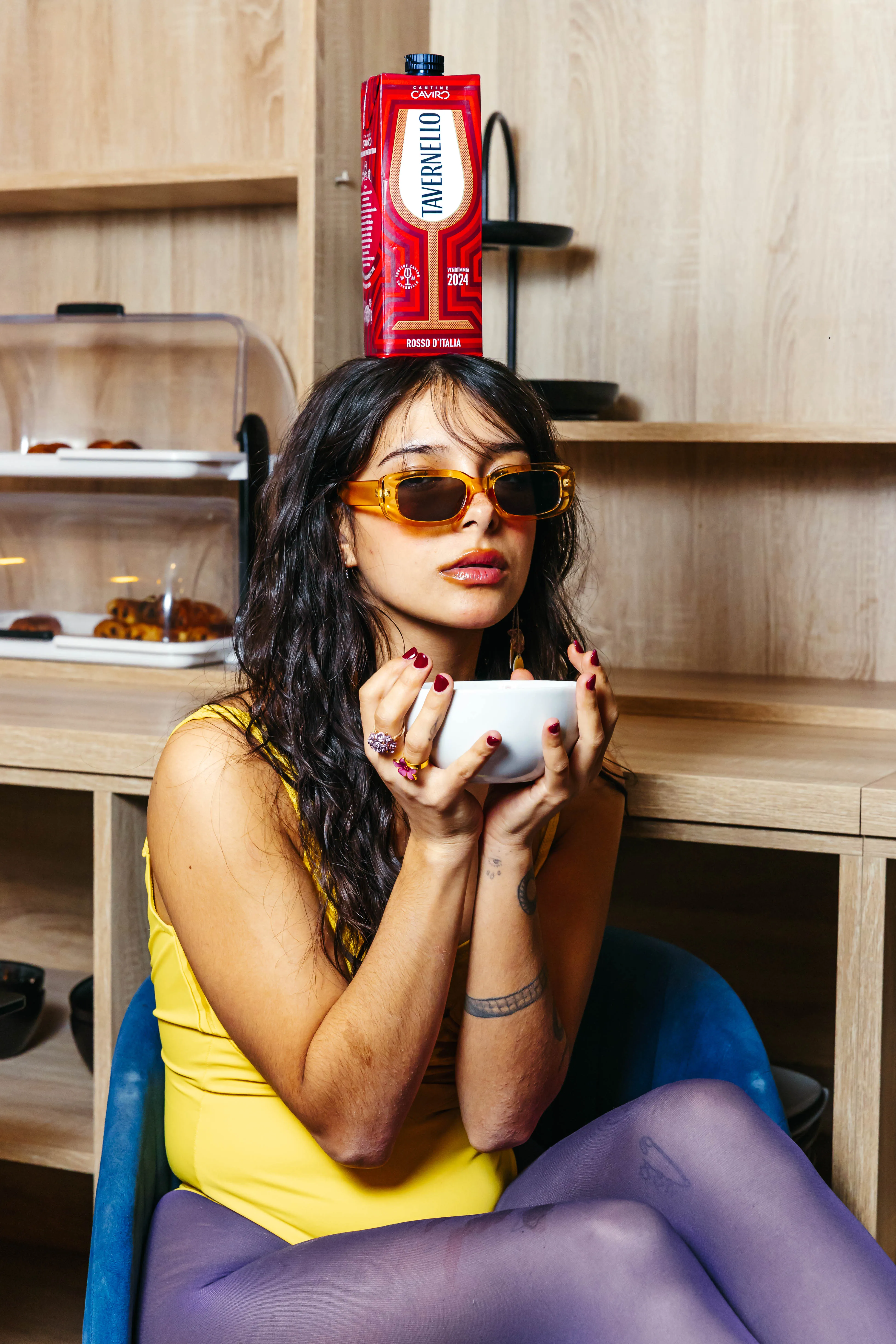 Model with sunglasses sipping coffee at the breakfast buffet